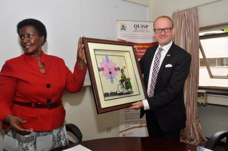 The outgoing ambassador of Sweden Urban Andersson receives a gift from the Minister of Trade Amelia Kyambadde during a farewell at the Ministry of Trade Headquarters in Kampala on August 9, 2016. Photo by Francis Emorut