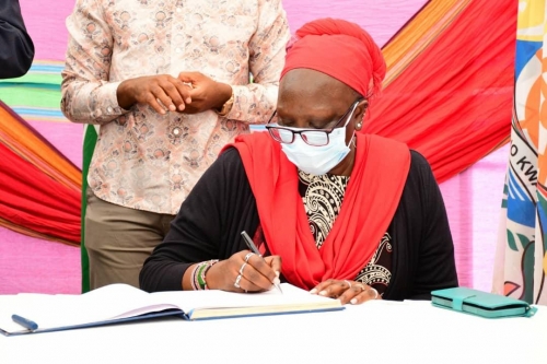 Kenyas-Cabinet-Secretary-Hon.-Betty-Maina-signs-the-visitors-book-at-the-opening-ceremony-of-the-Symposium-on-Wed-8th-Sept-2021.